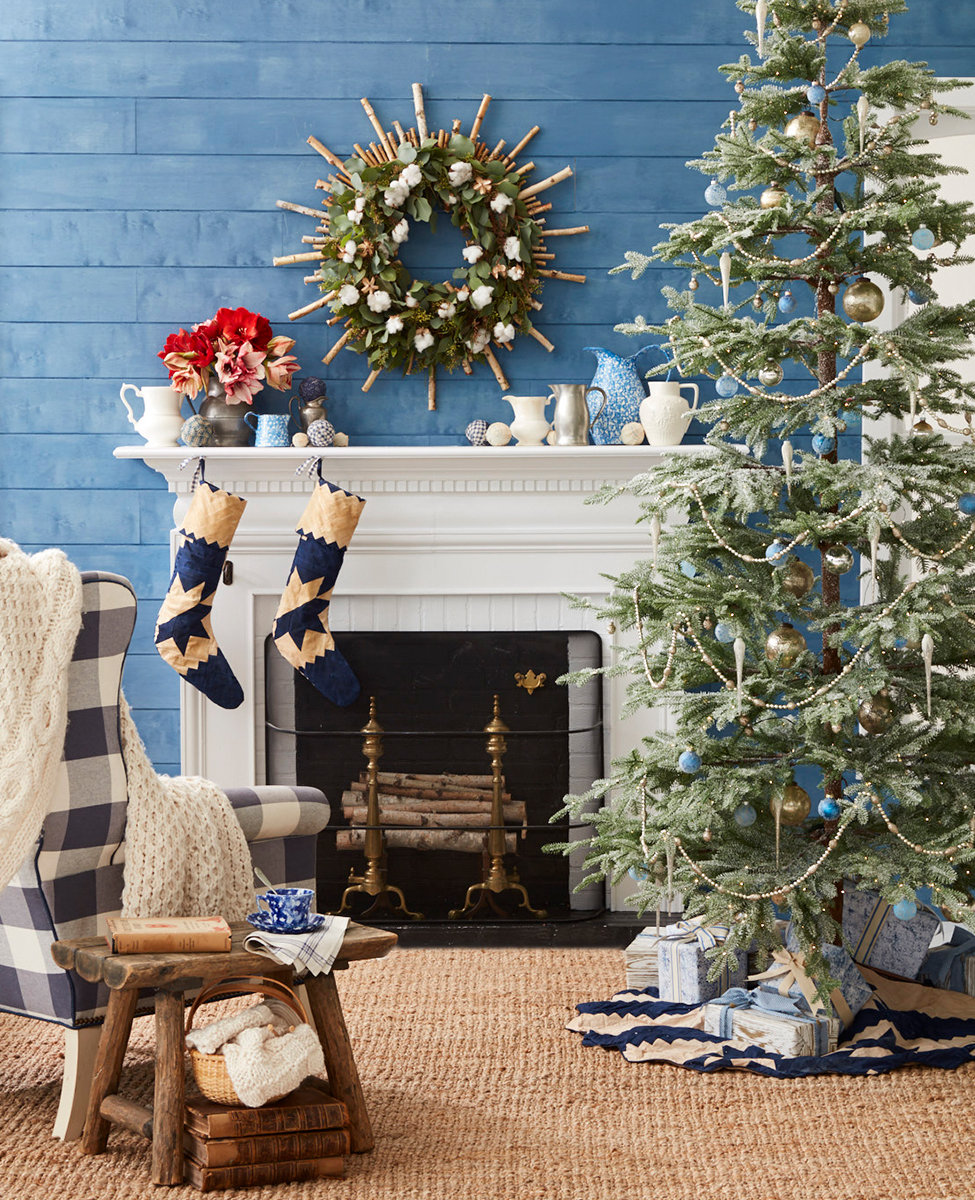 Living room set decorated for Christmas in the country with tree and faux fireplace
