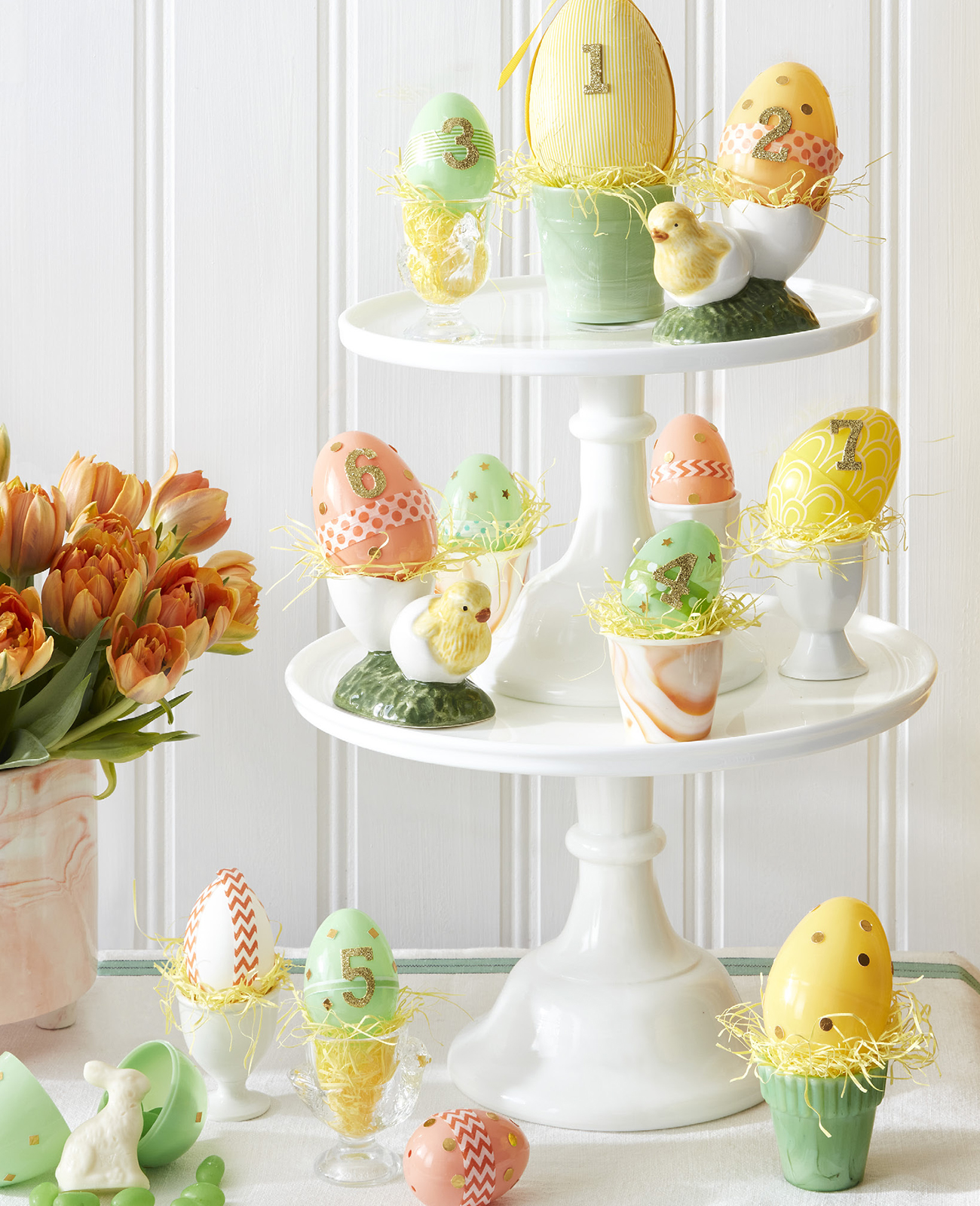 Easter advent calendar with painted eggs on stacked cake pedestals