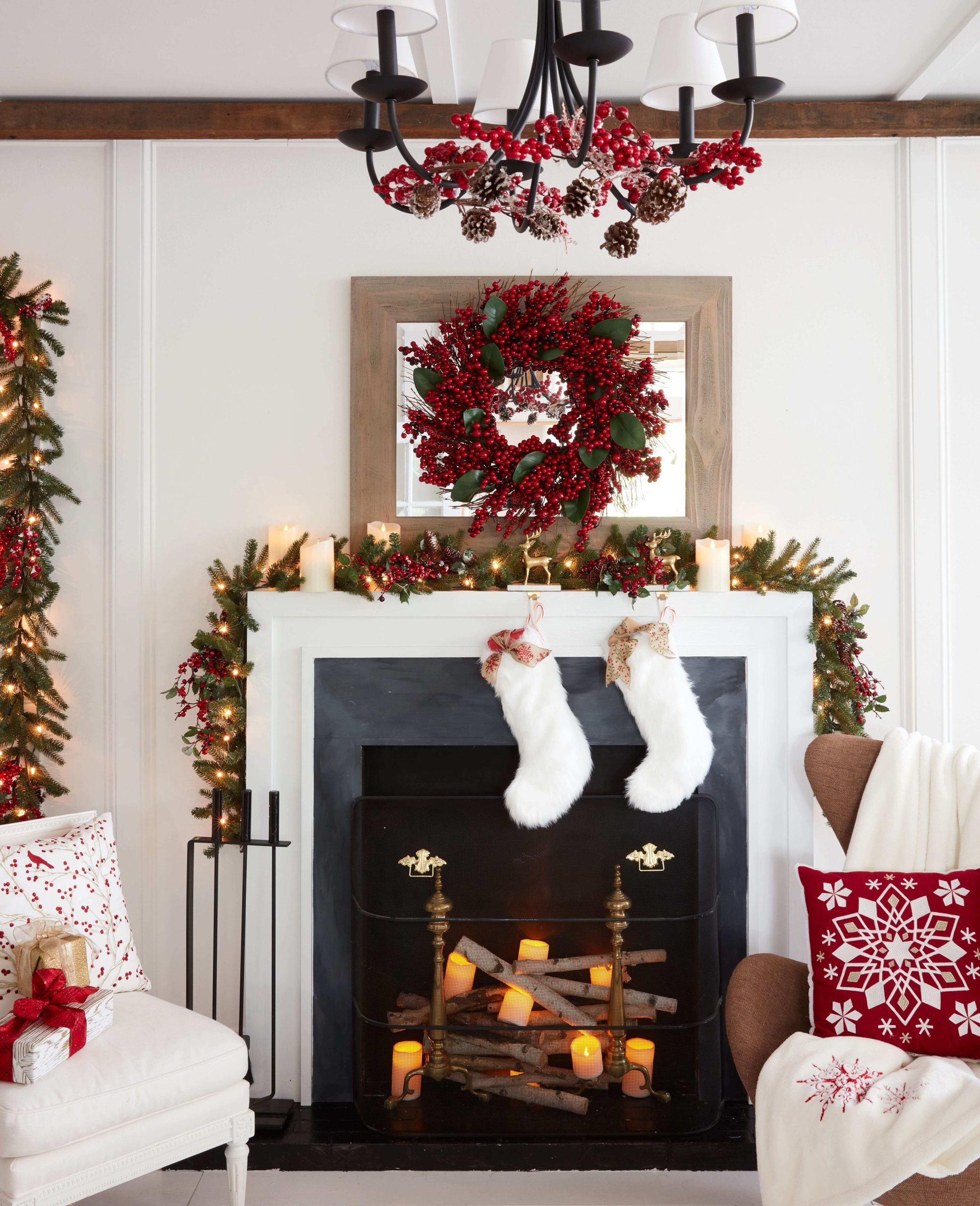 Living room set decorated for Christmas with stockings hanging over a faux fireplace