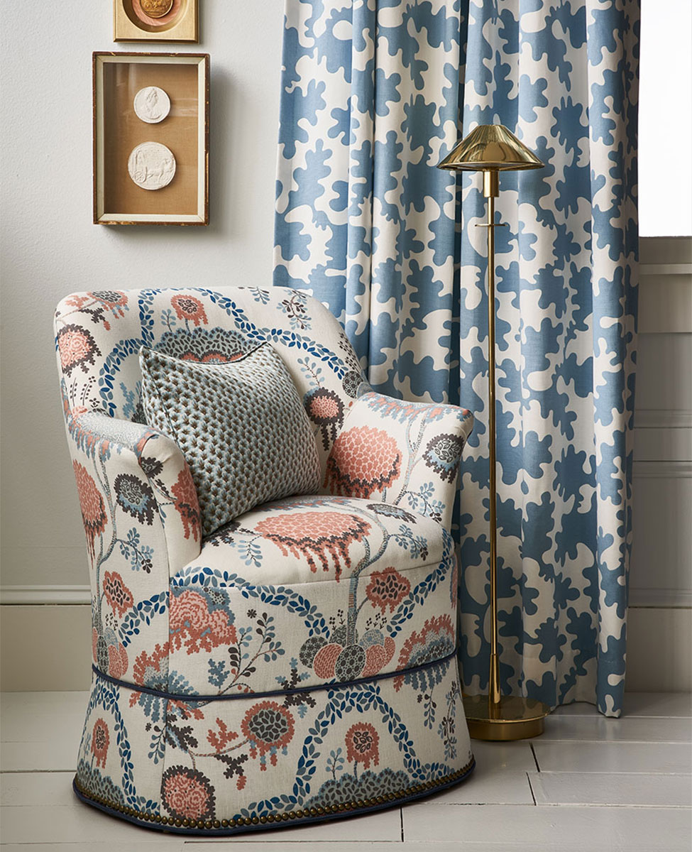 Vignette with upholstered armchair and curtains