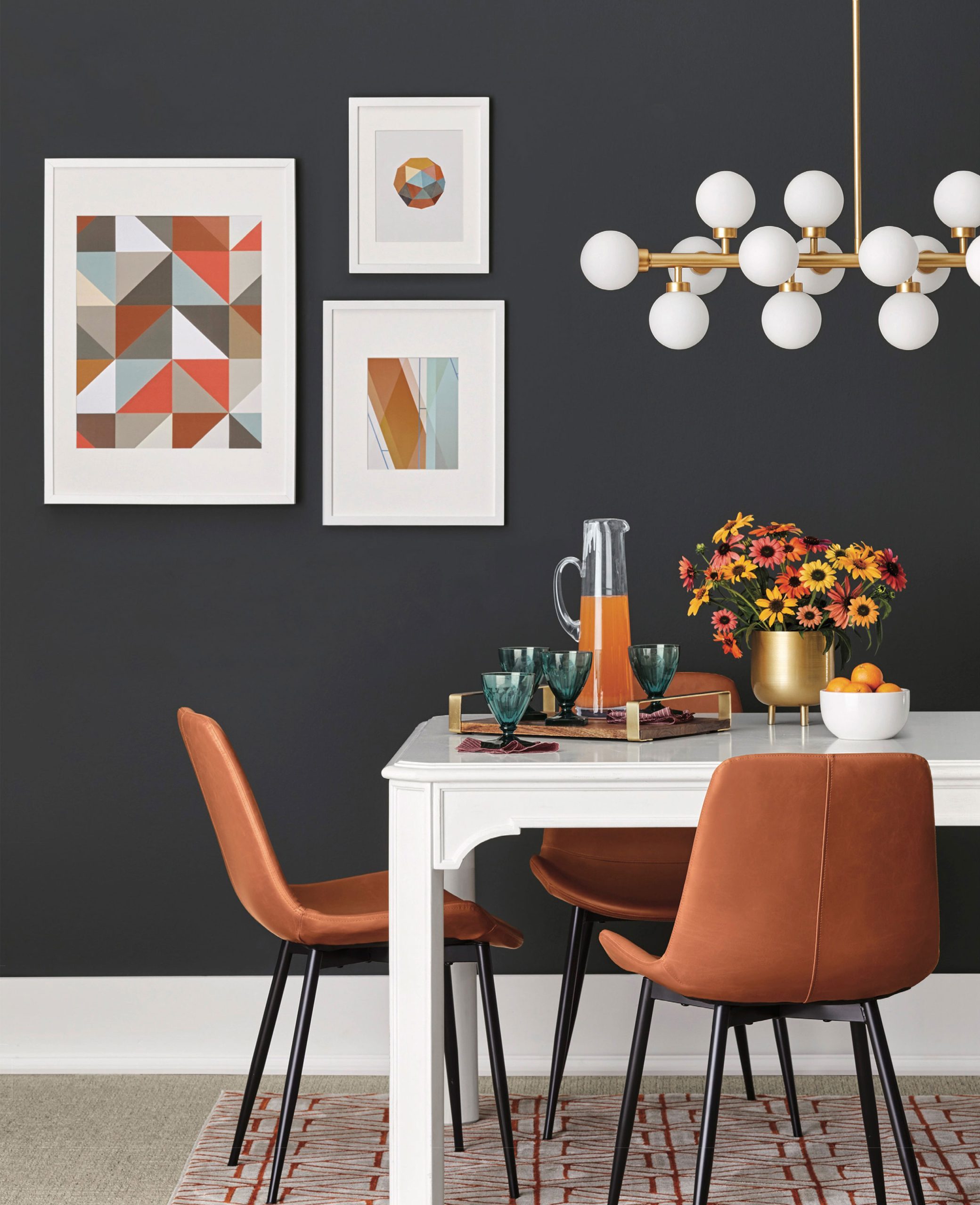 Dining room set with black walls and abstract art
